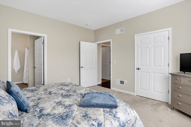 bedroom featuring light colored carpet