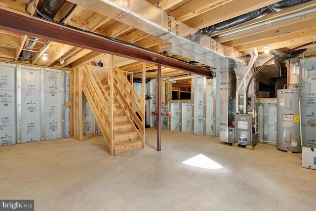 basement with gas water heater, electric water heater, and heating unit