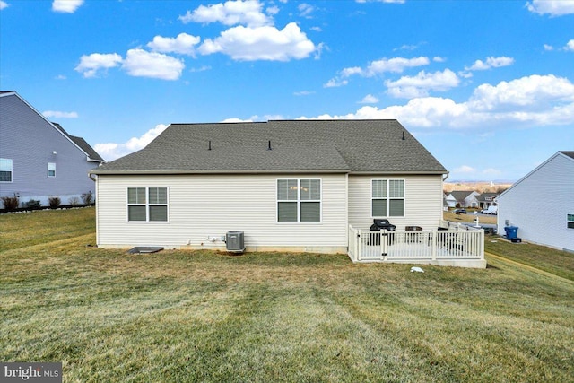 back of house featuring a yard and central AC unit