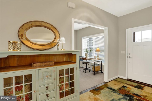 view of carpeted foyer entrance