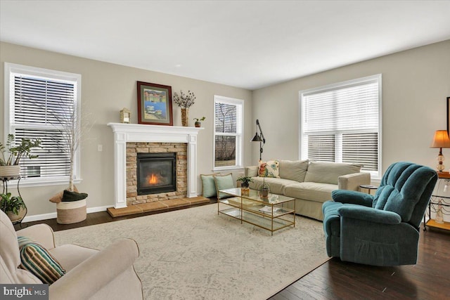 living room featuring dark wood-type flooring and a fireplace