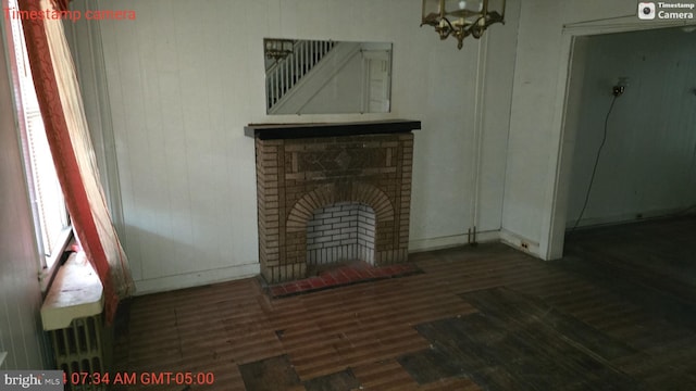 living room with dark hardwood / wood-style flooring and a fireplace