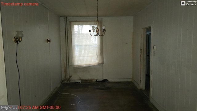 unfurnished dining area with a chandelier