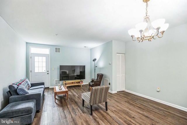 living room featuring wood-type flooring and a chandelier