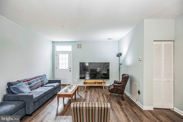 living room featuring dark wood-type flooring