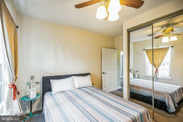 carpeted bedroom with ceiling fan and a closet