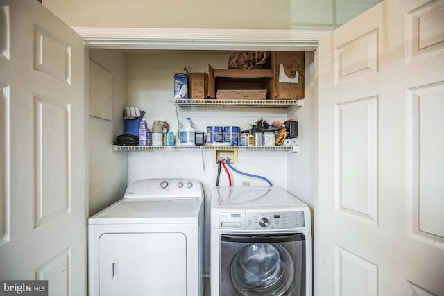 washroom with washing machine and clothes dryer