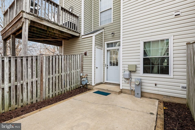 view of exterior entry featuring a patio