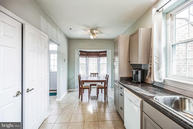 kitchen with light tile patterned floors, sink, dishwasher, and ceiling fan