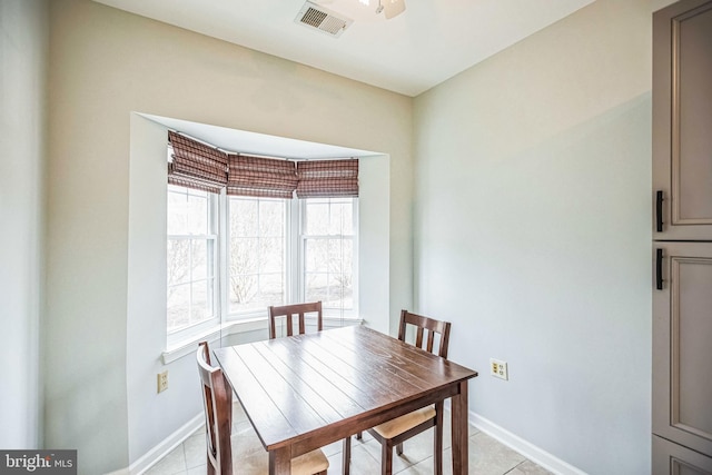 tiled dining room featuring ceiling fan