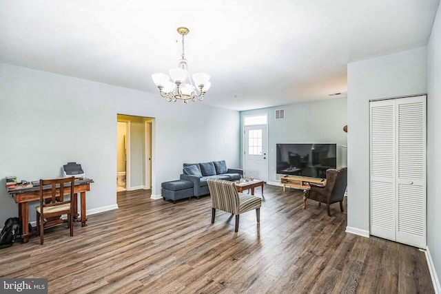 living room with an inviting chandelier and wood-type flooring