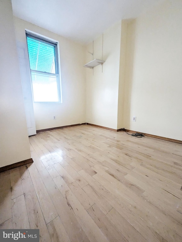 empty room with light hardwood / wood-style floors