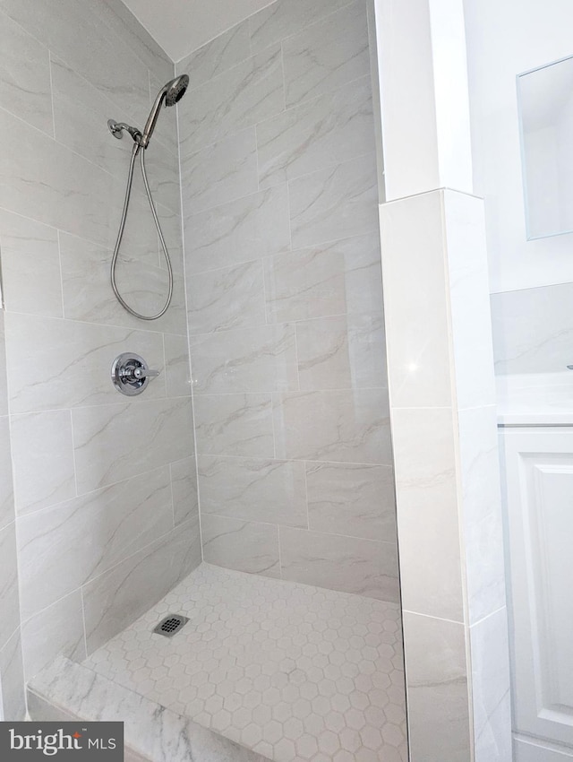 bathroom with a tile shower