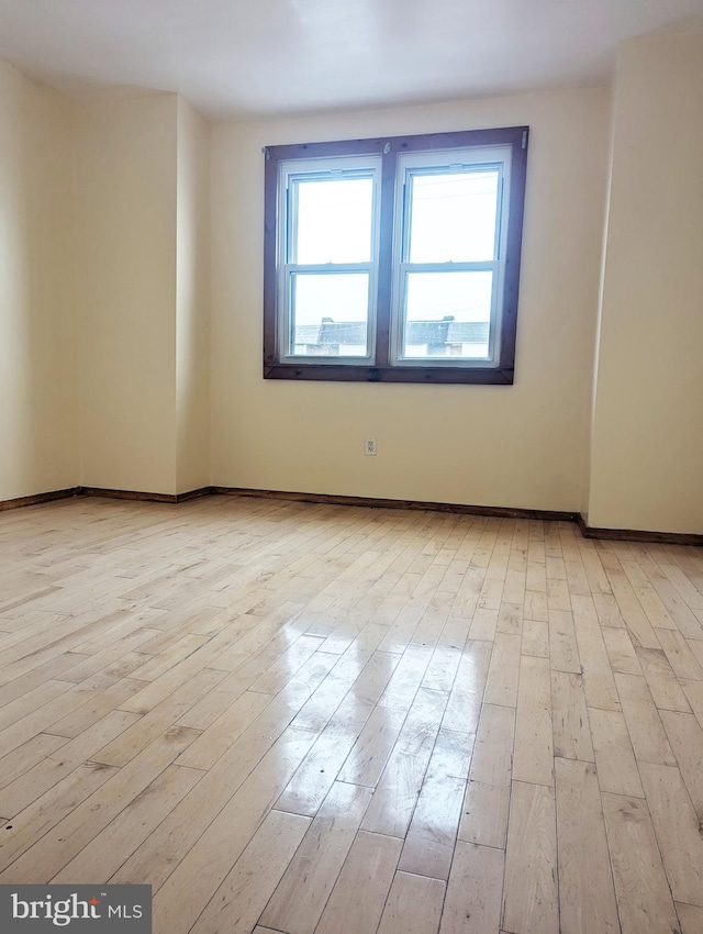 spare room with light hardwood / wood-style floors