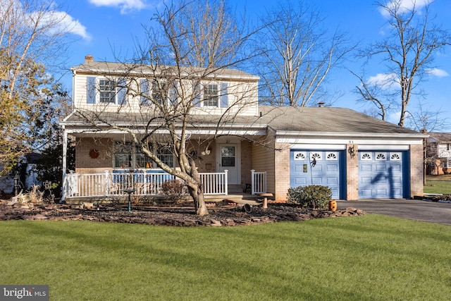 view of front facade with a garage, a front yard, and covered porch