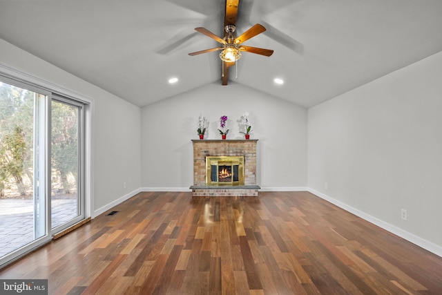 unfurnished living room with dark hardwood / wood-style flooring, a brick fireplace, lofted ceiling with beams, and ceiling fan