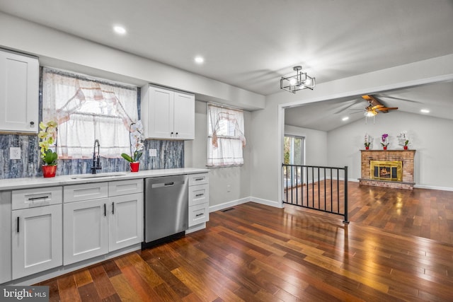 kitchen featuring white cabinetry, dark wood-type flooring, dishwasher, and sink