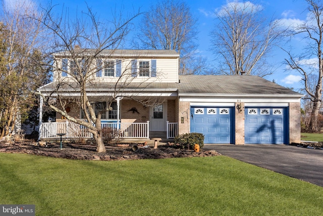 view of front of property with a garage, a front lawn, and a porch