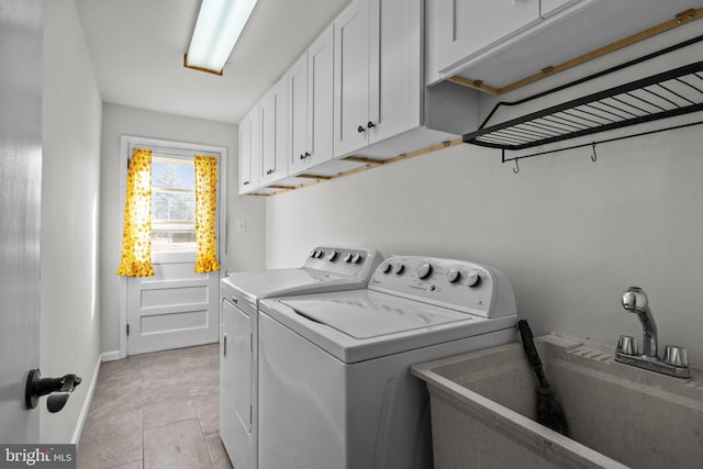 laundry area with cabinets, sink, and washer and dryer