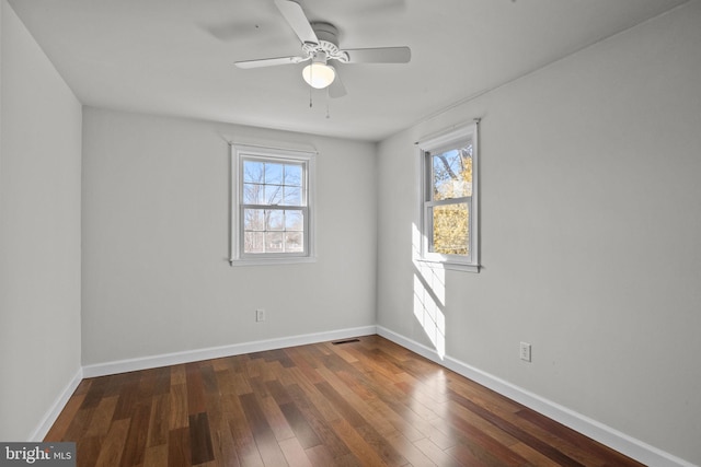 unfurnished room with dark wood-type flooring, ceiling fan, and plenty of natural light