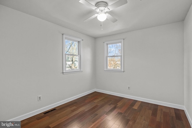 empty room with dark wood-type flooring and ceiling fan