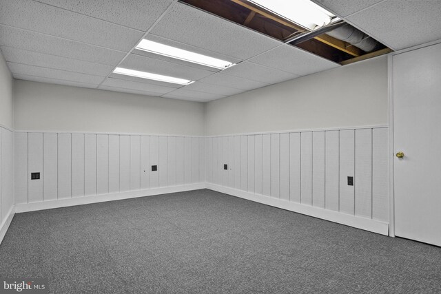 carpeted spare room featuring a paneled ceiling