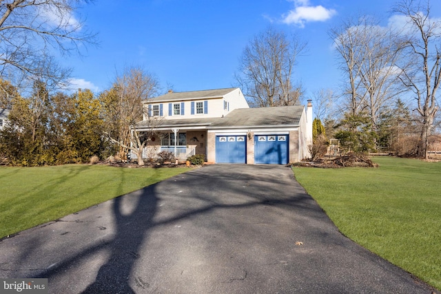 view of front facade with a porch, a garage, and a front yard