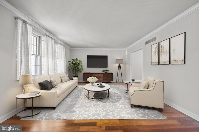 living room with hardwood / wood-style flooring and crown molding