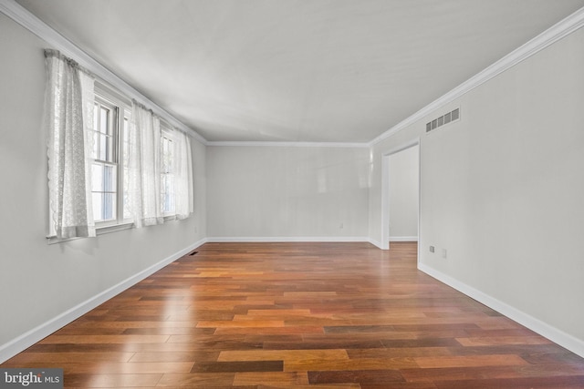 unfurnished room featuring dark wood-type flooring and ornamental molding