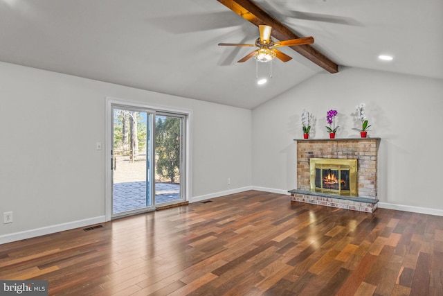 unfurnished living room with vaulted ceiling with beams, dark wood-type flooring, a brick fireplace, and ceiling fan