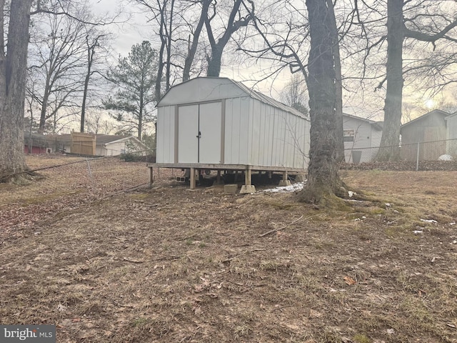 view of shed featuring fence