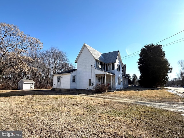 view of home's exterior with a storage shed and a yard