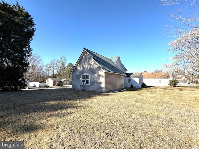 view of home's exterior with a yard