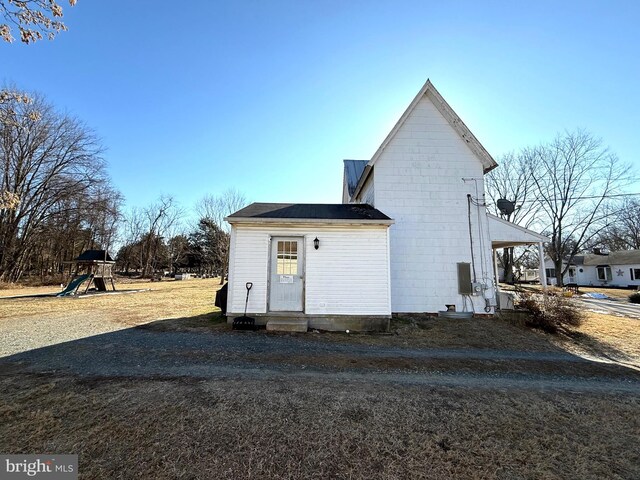 view of side of home with a playground