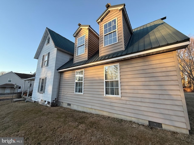 back of house with a lawn