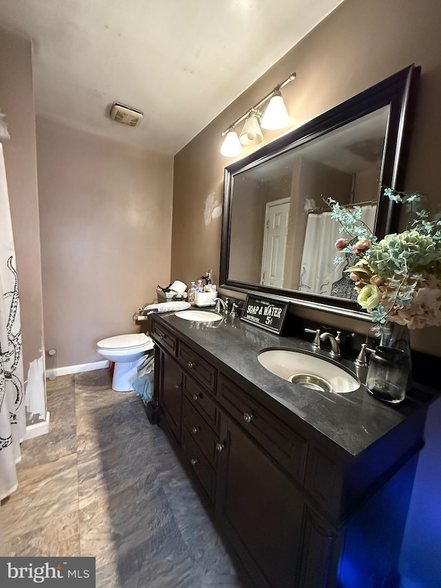 bathroom with vanity and toilet