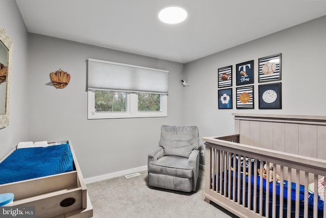 carpeted bedroom featuring a crib