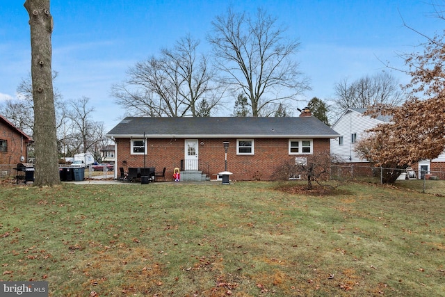 back of house with a lawn