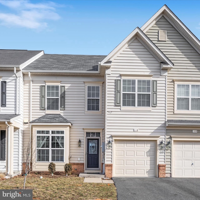 multi unit property featuring a garage