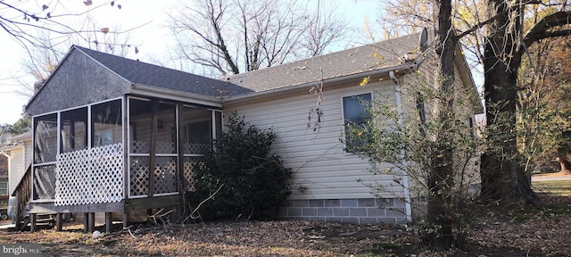 rear view of property with a sunroom