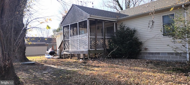 rear view of house featuring a sunroom