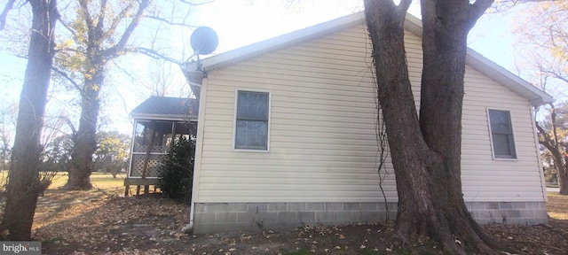 view of home's exterior with a sunroom