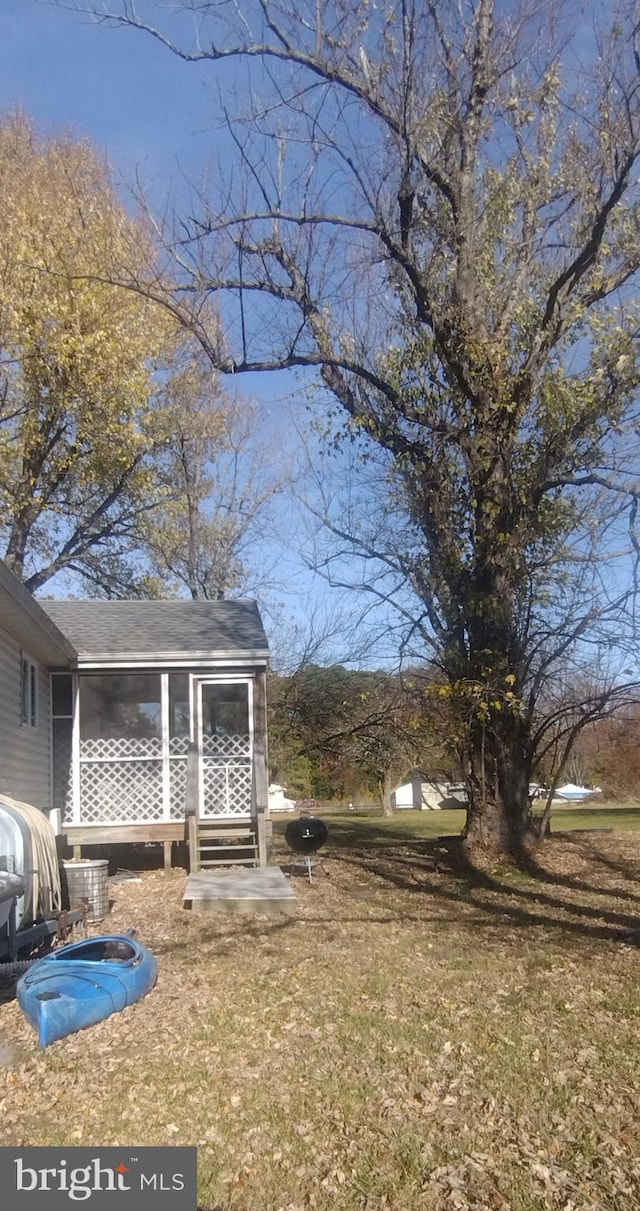 view of yard featuring a sunroom