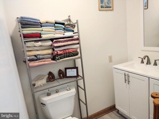 bathroom featuring hardwood / wood-style flooring, vanity, and toilet