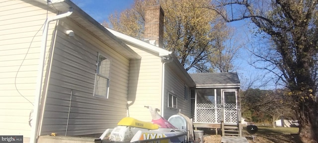 view of home's exterior with a sunroom