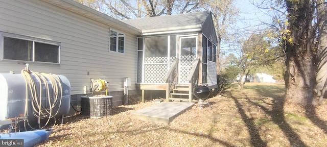 exterior space featuring cooling unit and a sunroom