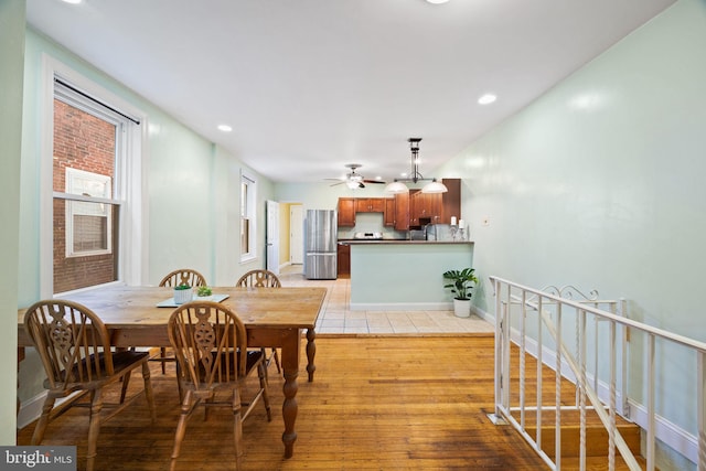 dining room featuring ceiling fan and light wood-type flooring