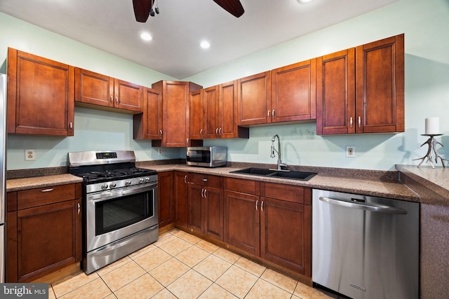 kitchen featuring ceiling fan, appliances with stainless steel finishes, sink, and light tile patterned floors