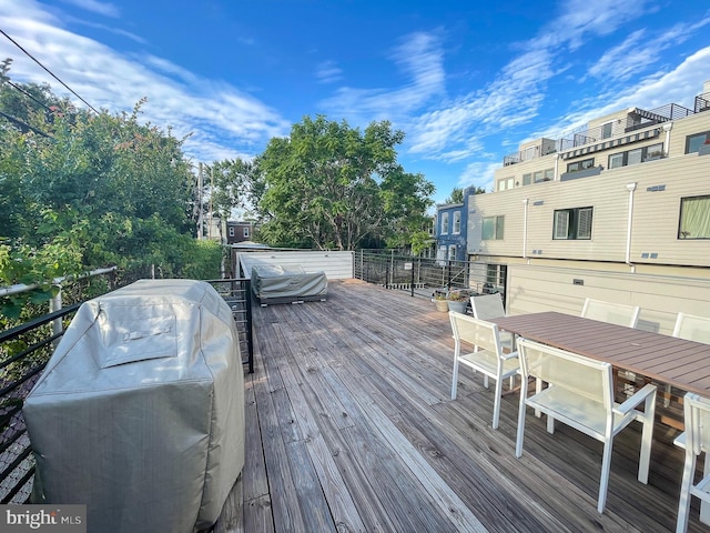 wooden deck featuring a grill