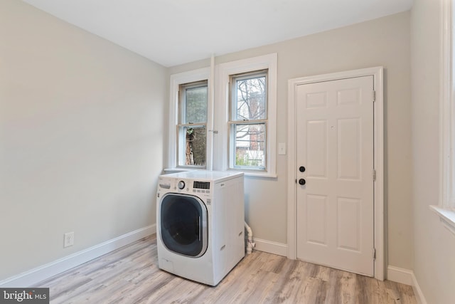 laundry room featuring washer / clothes dryer and light wood-type flooring